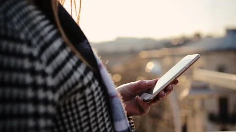 Close up of female hands using smartphone on the balcony of her apartment Stock Footage 61838387