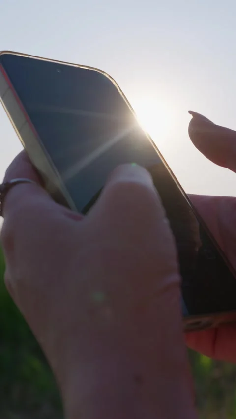 Close Up of Female Hands Using Smartphone Outdoors Under Bright Sun Stock Footage 343564425