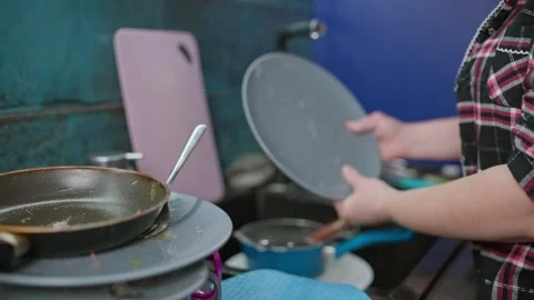 Close-up of female hands using a sponge and soap to wash dirty plates at home. Stock Footage 309054424