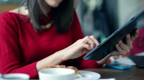 Close up of female hands using tablet computer in cafe HD Stock Footage