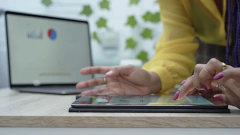 Close-up of female hands using a tablet in the office. Stock Footage 148670431