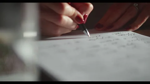 Close-up female hands write private letter on white paper, red pen and manicure Stock Footage 220331259