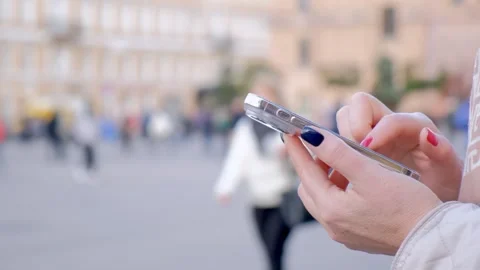 Close up of female hands writing a message on a smartphone in the summer on the Stock Footage 276222516