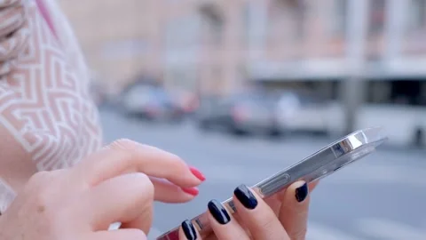 Close up of female hands writing a message on a smartphone in the summer on the Stock Footage 276289115