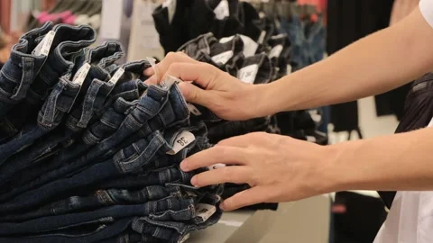 Close-up of the female hands of a young lady, quickly sorting through a stack of Stock Footage 220106464