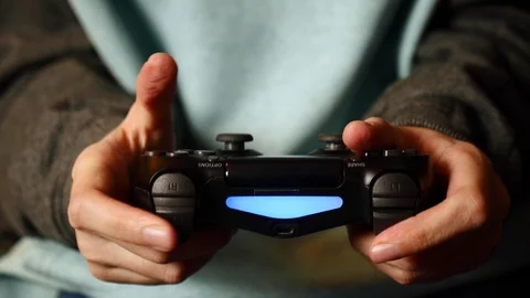 Close-up of female holding a controller and playing video game. PlayStation 4. Stock Footage 127502121