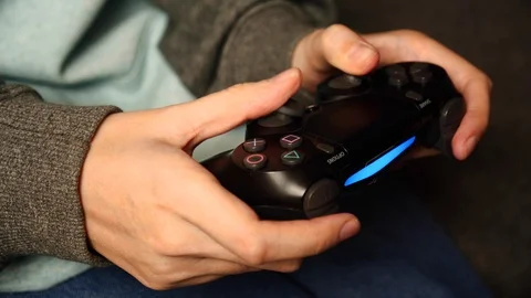 Close-up of female holding a controller and playing video game. PlayStation 4. Stock Footage 127502243