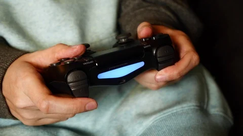Close-up of female holding a controller and playing video game. PlayStation 4. Stock Footage 127502370