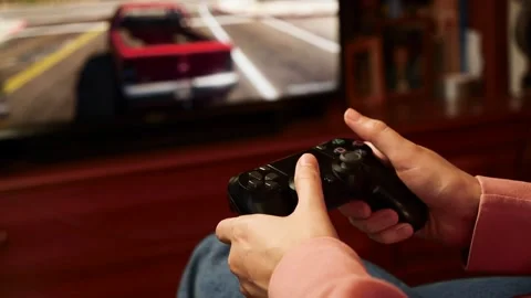 Close-up of female holding a controller and playing video game. Stock Footage 132618836
