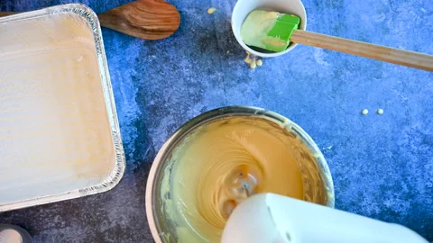Close-up of Female in the kitchen with mixer mixing an organic delicious doug Stock Footage 154768030