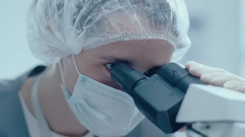 Close-Up of Female Lab Worker Using Microscope Stock Footage 243398189