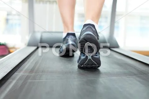 Close-up of female legs running on treadmill Stock Photos