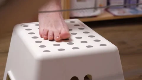 Close-up female legs step up step and climb onto depilation couch. Stock Footage 147096321