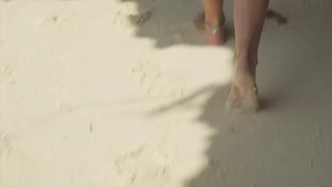 Close up of female legs walking on sandy beach Stock Footage 104901895