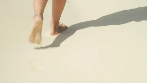 Close up of female legs walking on sandy beach Stock Footage 104902047