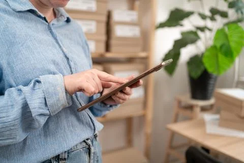 Close-up of Female Logistics Manager Using Tablet Computer with Online Orders Stock Photos