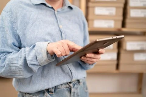 Close-up of Female Logistics Manager Using Tablet Computer with Online Orders Stock Photos