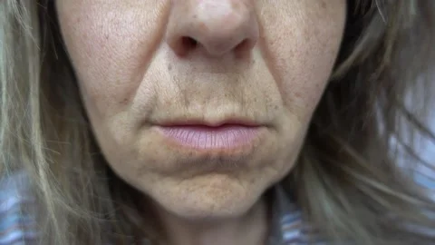 Close up female lower face with thin upper lip Stock Footage 142226739