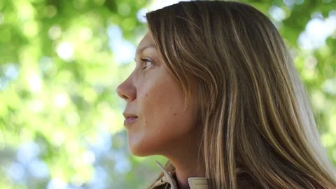 Close-up of female in a macintosh looking on the sides Stock Footage 77201259