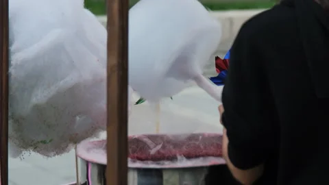 Close-up of female making cotton candy outdoors 動画素材 256598257