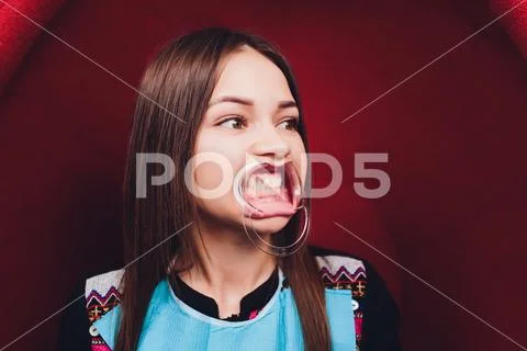 Close up of female mouth with retractor. Doctor flossing the teeth. Dental Gag. Stock Photos
