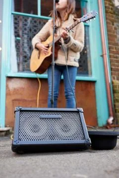 Close Up Of Female Musician Busking Playing Acoustic Guitar Outdoors In Street Stock Photos