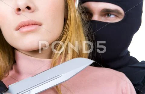 Close-up of female neck with big sharp knife in killers hand near by Stock-Fotos