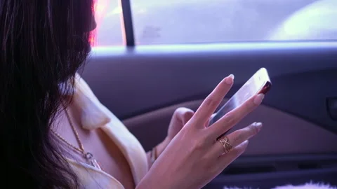Close up of female passenger hands using smartphone while commuting in a car Stock Footage 342492277