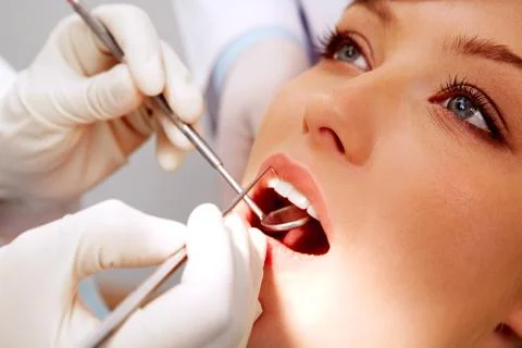 Close-up of female patient having her teeth examined by specialist Stock Photos
