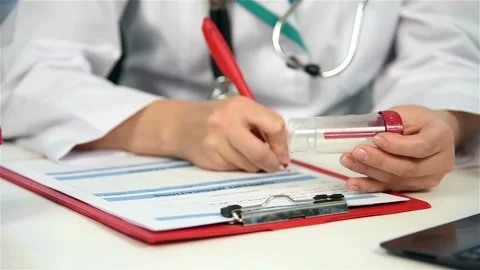 A close up of a female physician's hand writing out a prescription close up of Stock-Footage 336587551