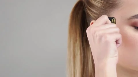 Close-up of female plug in micro chip to her head Stock Footage 146597380