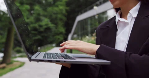 Close-up of female professional hands typing on a laptop while working online in Stock Footage 330743815