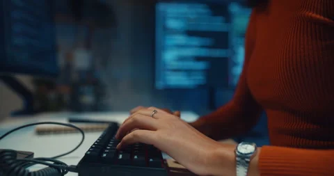 Close-up female programmer typing coding on keyboard working late in office. Vídeos de archivo 347148424