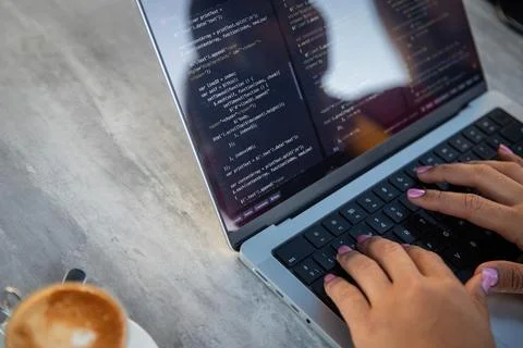 Close-up of a female programmer's hands writing some code, copy space on th.. Stock Photos