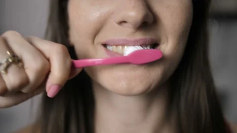 Close-up of female properly brushing white teeth Stock Footage 88005587