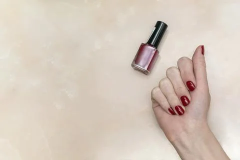 Close-up female red shellac on the nails, fresh gel polish, Home manicure, be Stock Photos