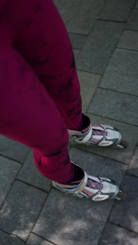 Close up of female rollerblades gliding over a paved path outdoors Видео 341476699