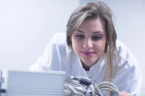 Close up of female scientist in lab using scanning electron microscope Stock Photos