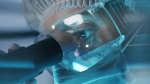 Close Up of Female Scientist Looking through Microscope Eyepiece Stock Footage 315131179
