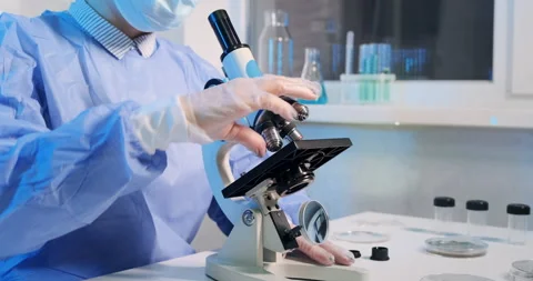 Close-up of female scientist working with microscope. 動画素材 150896846