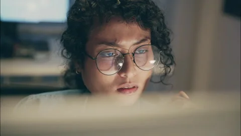 Close-up of a female software developer working late. Stock Footage 319000774