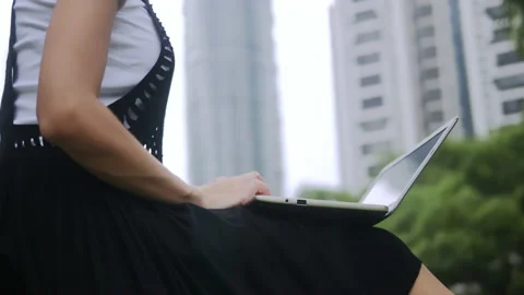 Close-up of female student hands typing message on laptop outdoors. Stock Footage 95586558