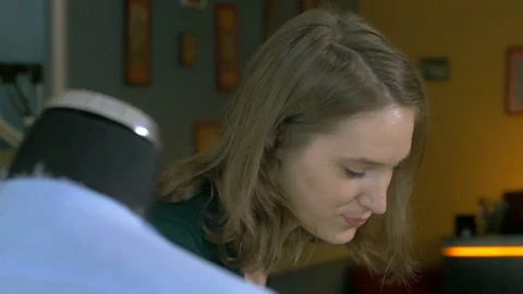 Close-up of female tailoring a jacket on model in small creative office. Stock Footage 80471635