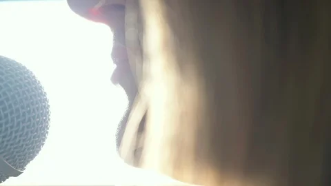 Close up of  Female Talking Singer Singing Into A Microphone Backlight Vidéo 128709010