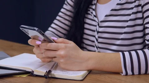 Close up female typing message on mobile at work Stock Footage 113465434