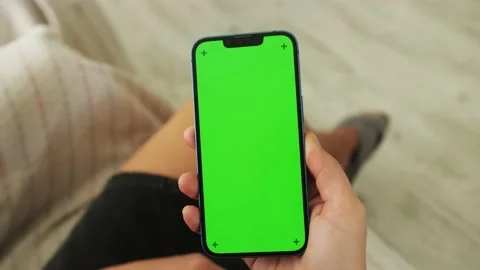 Close up of female using smartphone with green screen at home in living room. Stock Footage 222818931