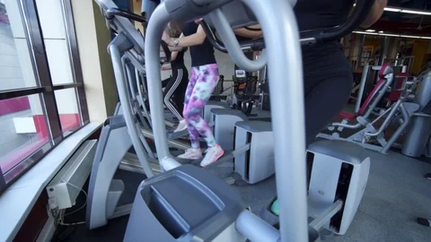 Close up of Female using Space Walker Equipment in Gym Stock Footage 122567777