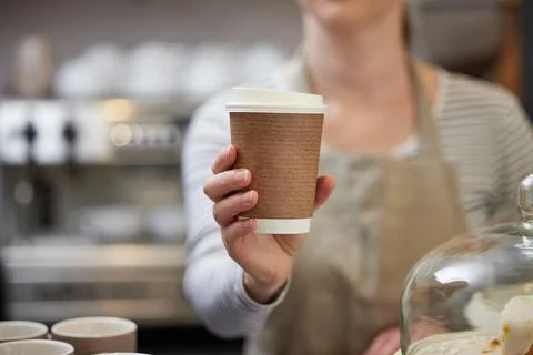 Close Up Of Female Worker in Cafe Serving Coffee In Sustainable Recyclable Cu Stock Photos
