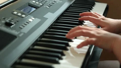 Close up of feminine hands gracefully playing piano keys, fingers dancing Stock Footage 311779798