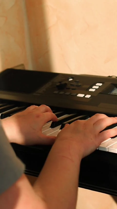 Close up of feminine hands gracefully playing piano keys, fingers dancing Stock Footage 311779810